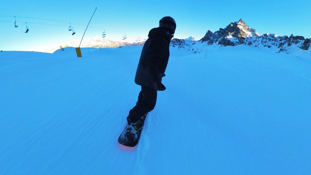 Snowboarding down the panoramic Mesola slope